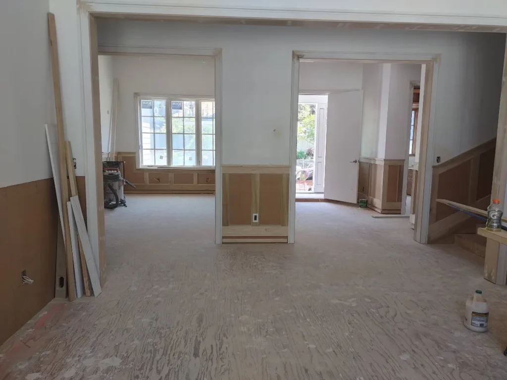 Spacious room with natural light and white walls.