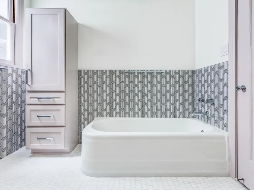 Modern bathroom with tile work around a freestanding tub.