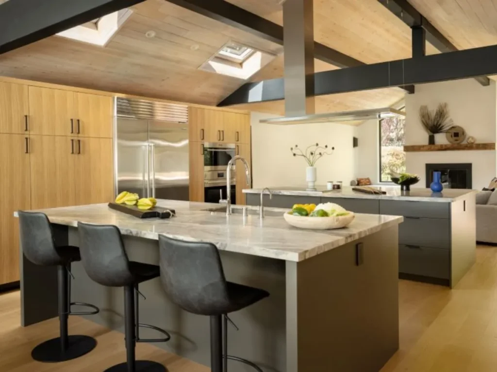 Open kitchen with high ceilings and bar seating.