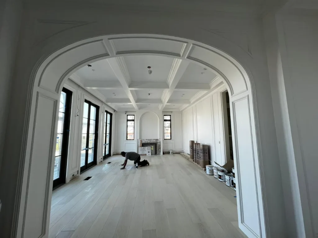 Curved hallway with large windows and wooden floors.