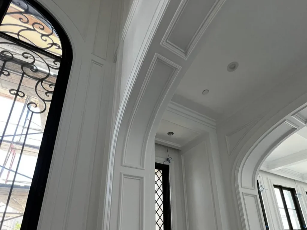 Curved walls with intricate molding details.