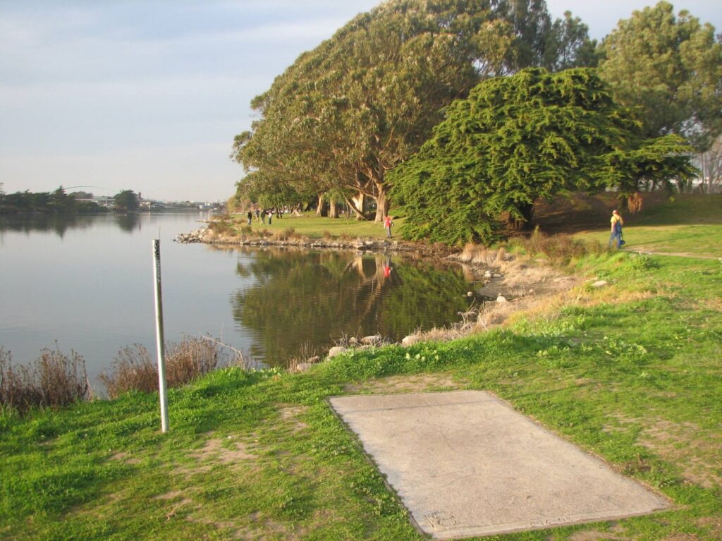 Peaceful park with a walking path by the water.