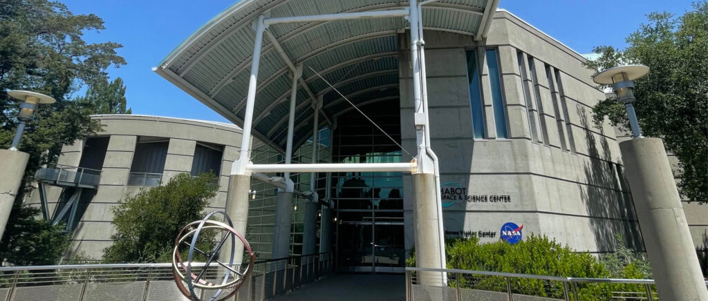 Contemporary building with curved, glass architecture.