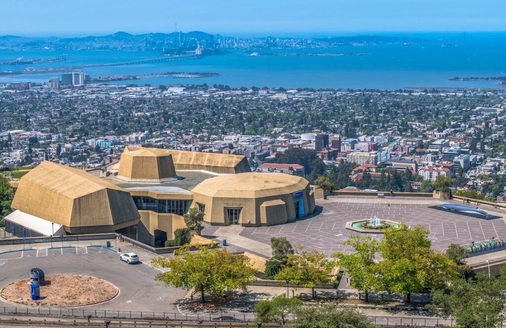 Aerial view of a city with rolling hills.