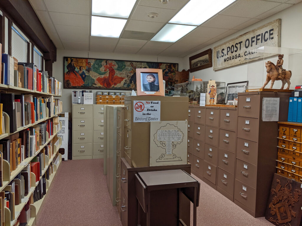 Bright, organized office with file cabinets and artwork.