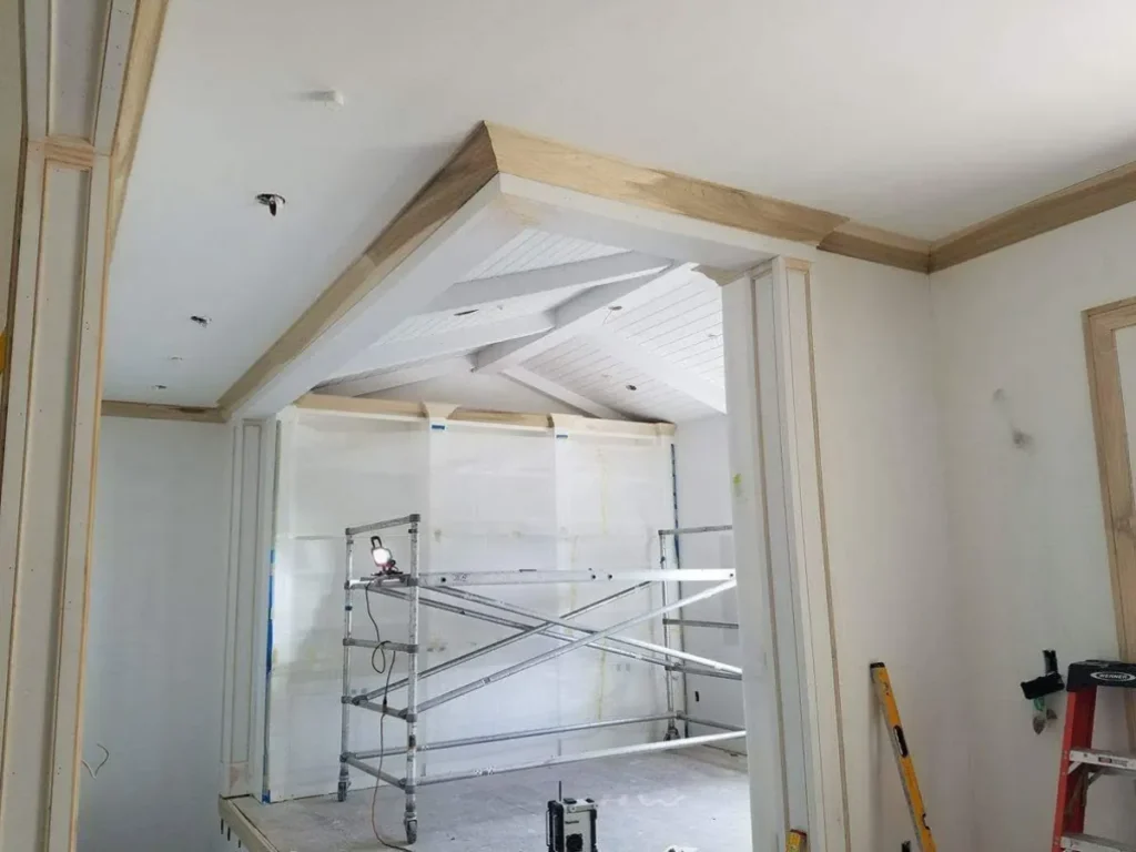 Construction site with ceiling work in progress.