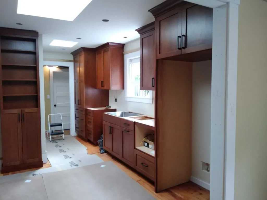 Wooden kitchen cabinetry in a bright space.
