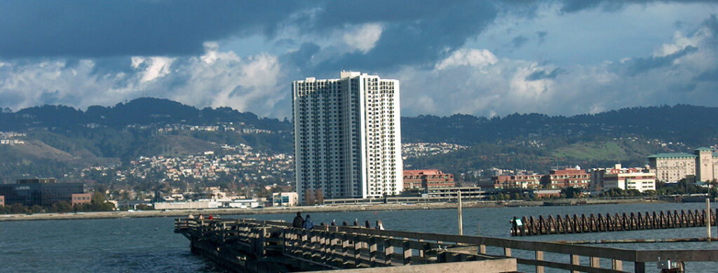 Skyline view of a tall building near water.