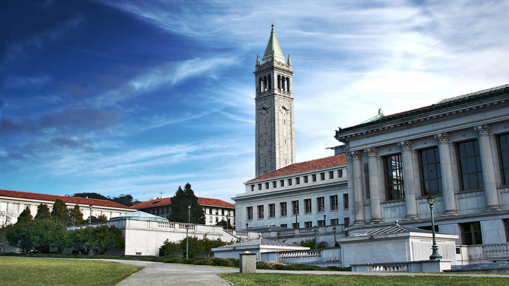 Historic clock tower with clear blue skies in the background.