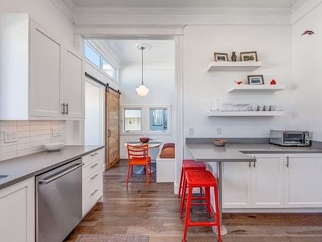 White kitchen with open shelves and light