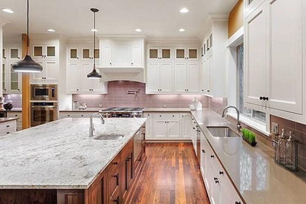 Large white kitchen with wide wooden counters.