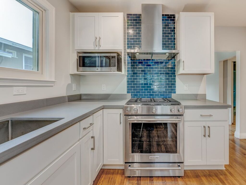 White kitchen with blue glass tile backsplash