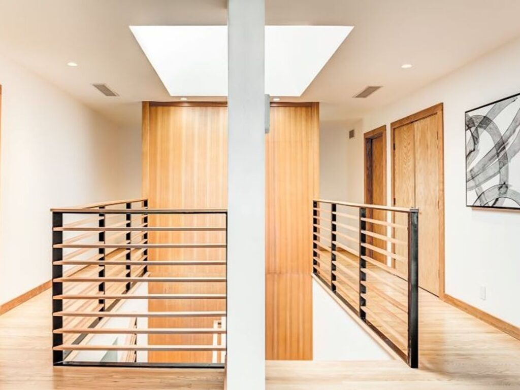 Interior staircase with wood and metal railing.