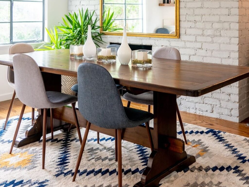 Dining room table with plants and rug