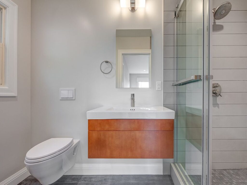 Bathroom vanity with wood cabinet, white sink