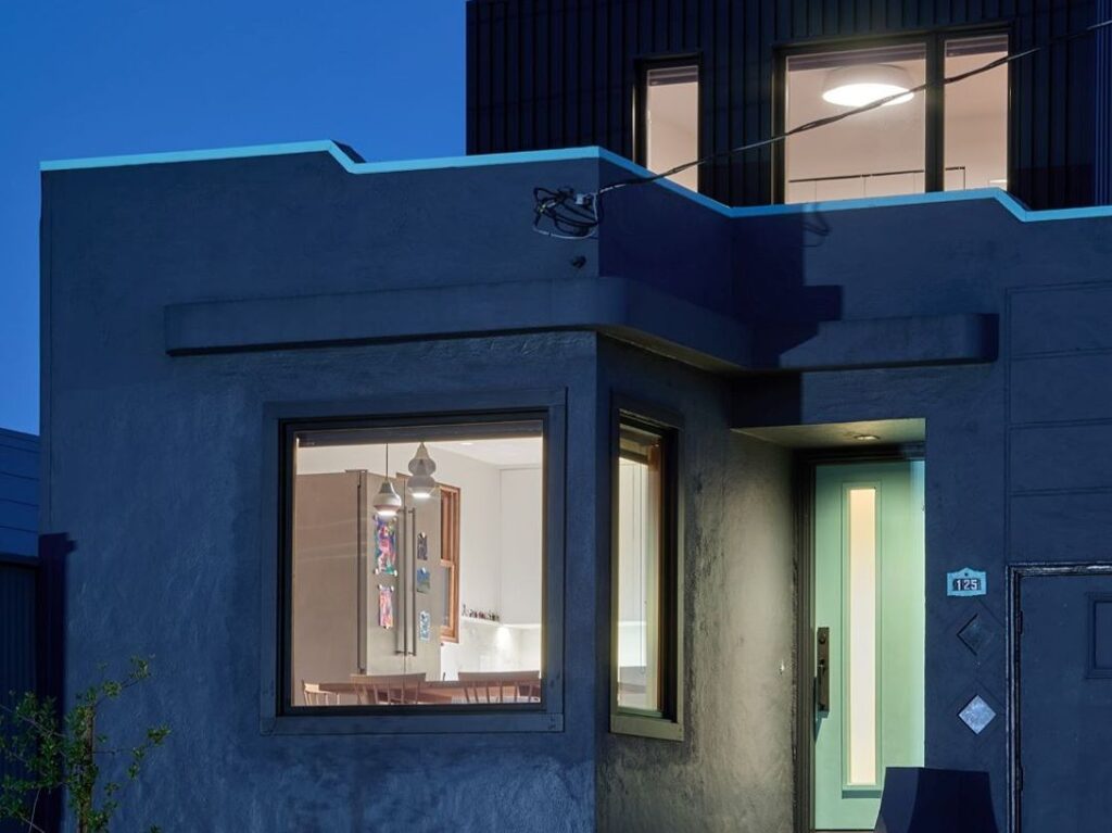 Building exterior at night with lit windows