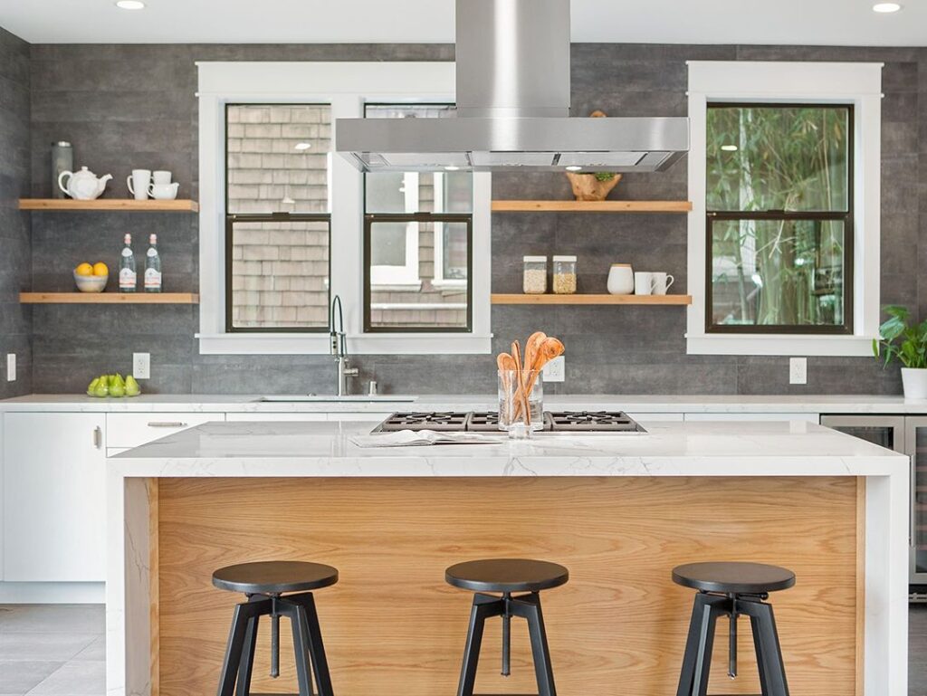 Kitchen counter with bar stools, window view.