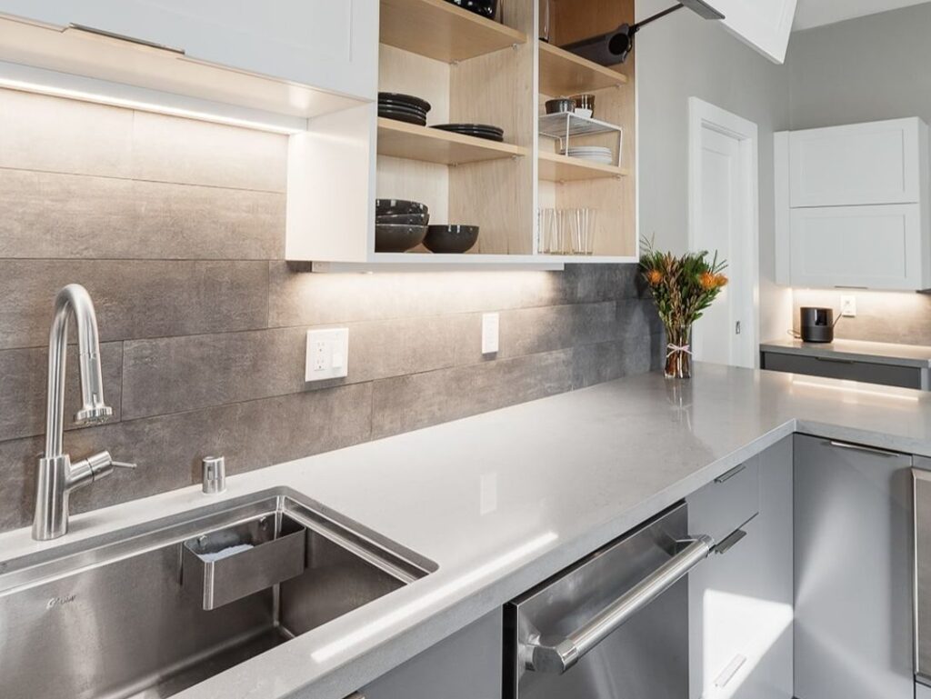 Kitchen sink area with under-cabinet lighting.