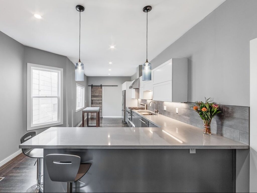 Bright kitchen with island and pendant lights