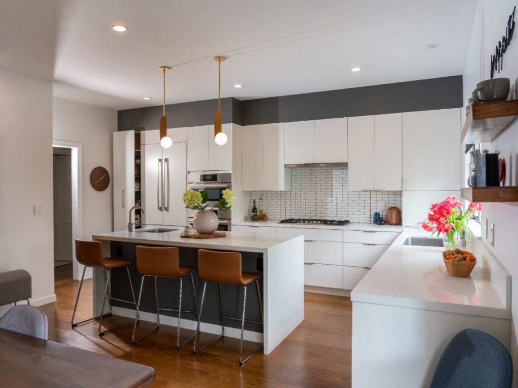 White and wood kitchen with island lighting