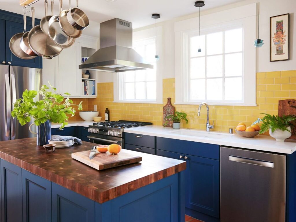 Blue kitchen with island and cookware rack