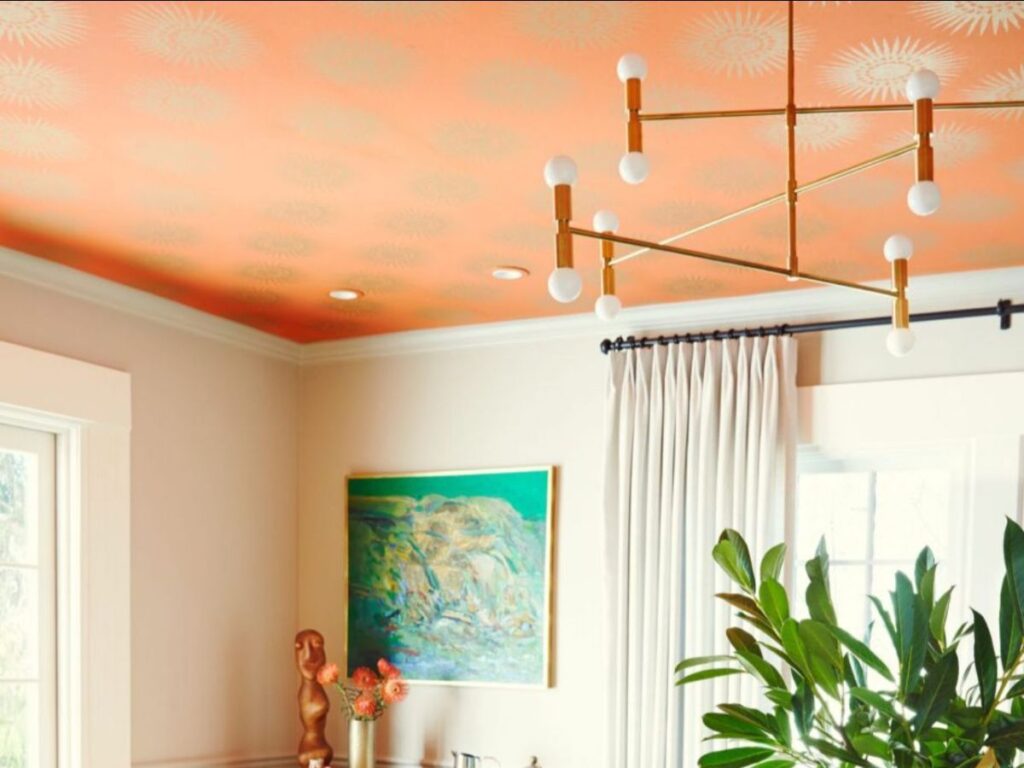 Room with orange ceiling and artwork