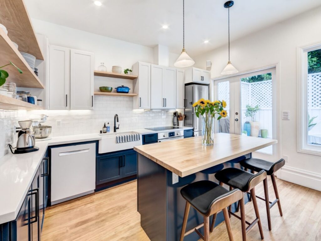 White kitchen with wood floors and island